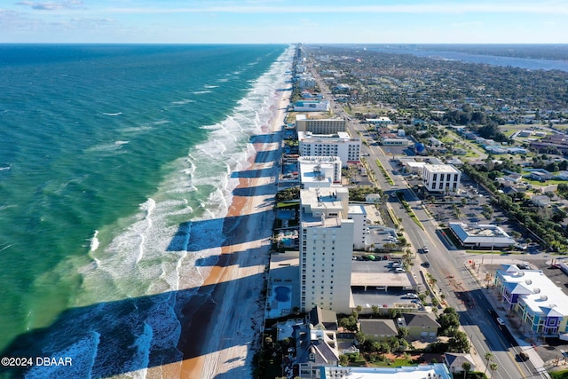 drone / aerial view featuring a water view and a view of the beach