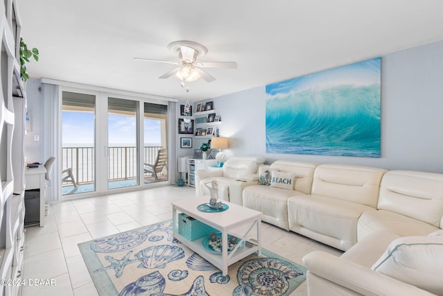 living room with ceiling fan and light tile patterned flooring