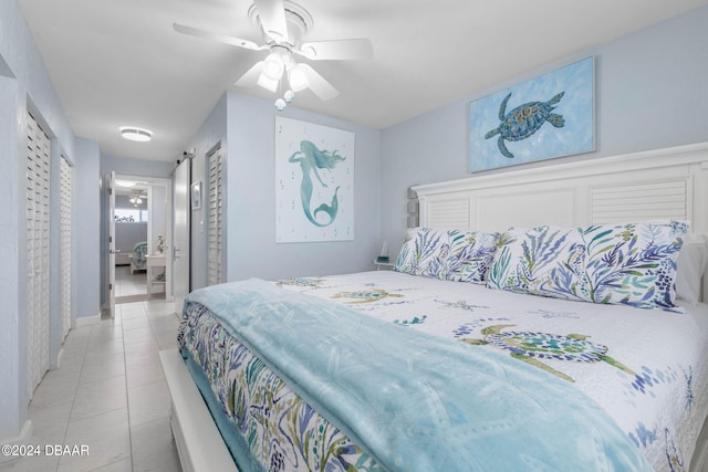 tiled bedroom featuring ceiling fan and ensuite bathroom