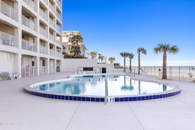 view of swimming pool with a patio