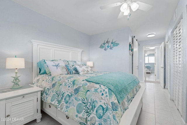 tiled bedroom featuring ceiling fan