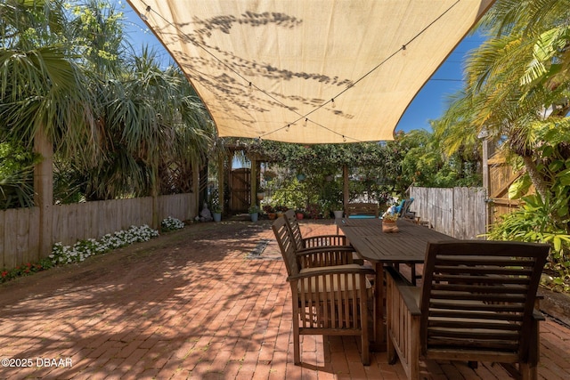 view of patio with outdoor dining space and a fenced backyard