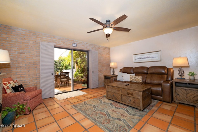 tiled living room featuring brick wall and a ceiling fan