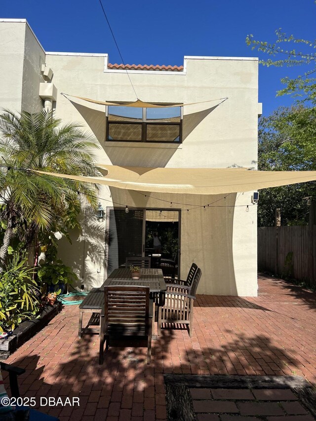 view of patio featuring outdoor dining space and fence