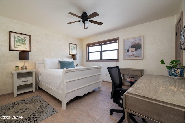 bedroom with a ceiling fan and tile patterned flooring