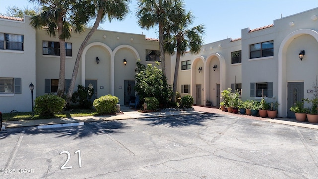 view of front of property featuring stucco siding and a tiled roof