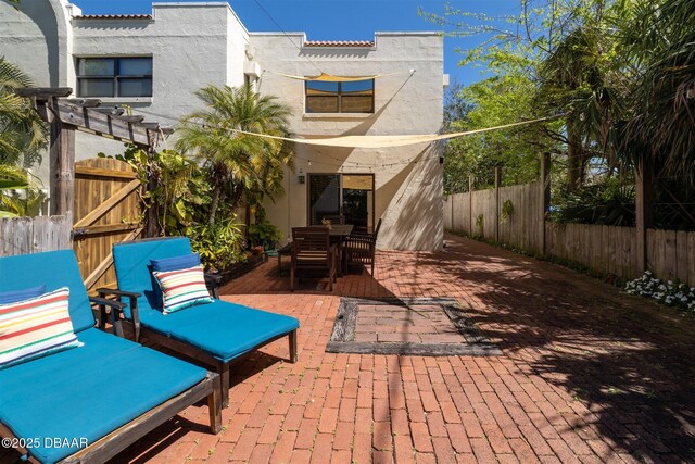 view of patio / terrace with a fenced backyard, outdoor dining space, and a pergola