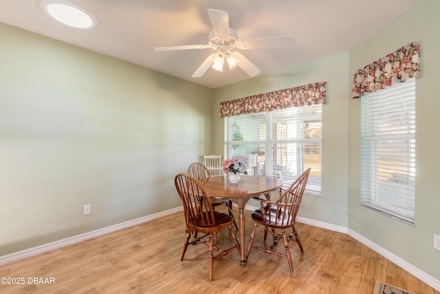 dining area featuring light hardwood / wood-style flooring and ceiling fan