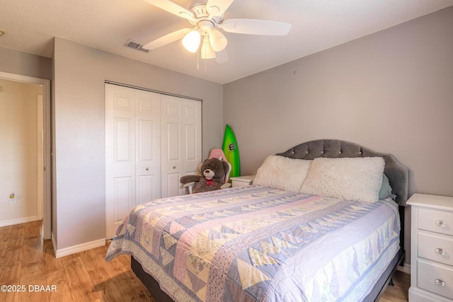 bedroom featuring ceiling fan, light wood-type flooring, and a closet