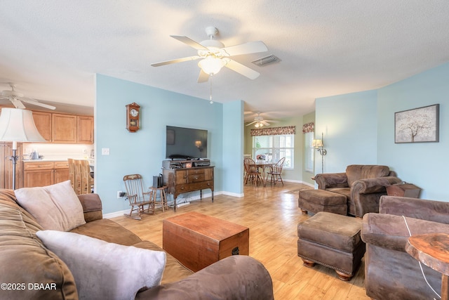 living room featuring light hardwood / wood-style floors and a textured ceiling