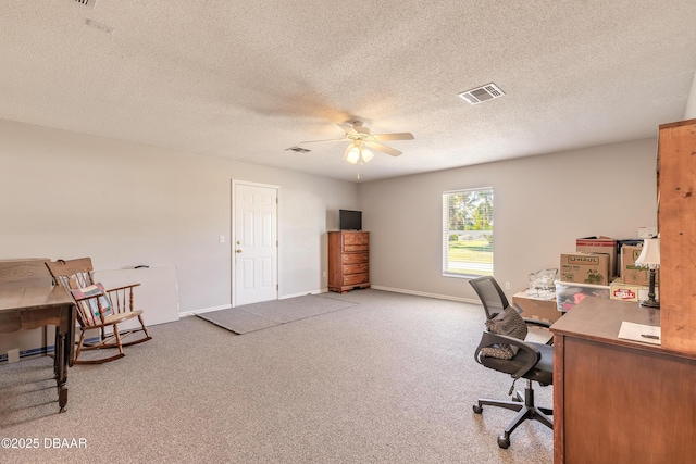 office area with a textured ceiling, carpet floors, and ceiling fan