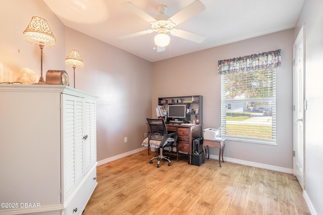 office with light wood-type flooring and ceiling fan