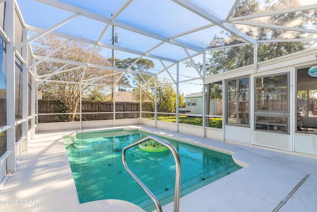 view of pool with a patio area and a lanai