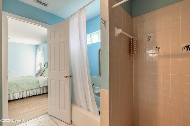 bathroom featuring tile patterned floors and shower / bath combo with shower curtain