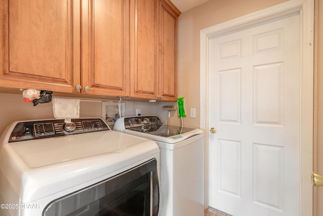 clothes washing area with cabinets and independent washer and dryer