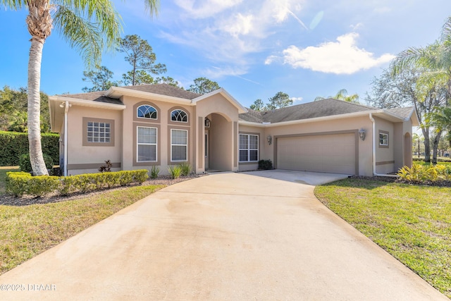 view of front facade with a garage and a front lawn