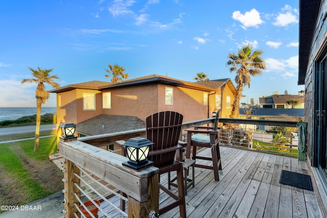 wooden terrace featuring a water view