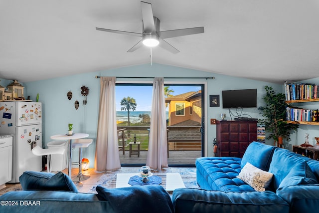 tiled living room featuring ceiling fan and lofted ceiling