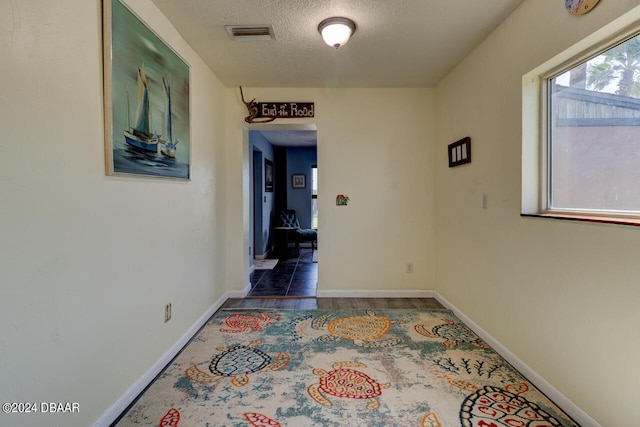 corridor with a textured ceiling