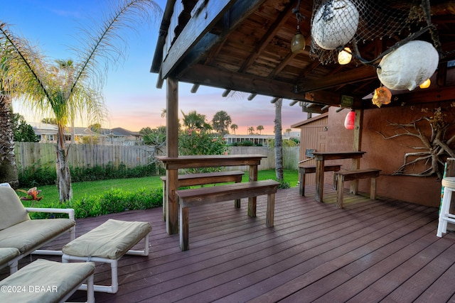 deck at dusk with a gazebo and a yard