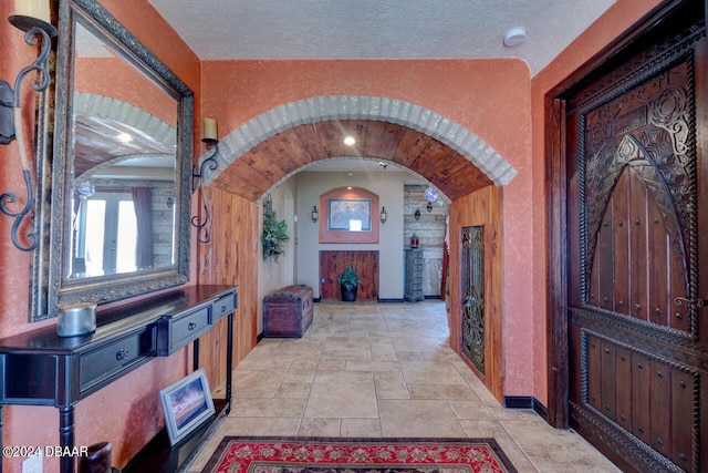 foyer featuring light tile patterned floors and a textured ceiling