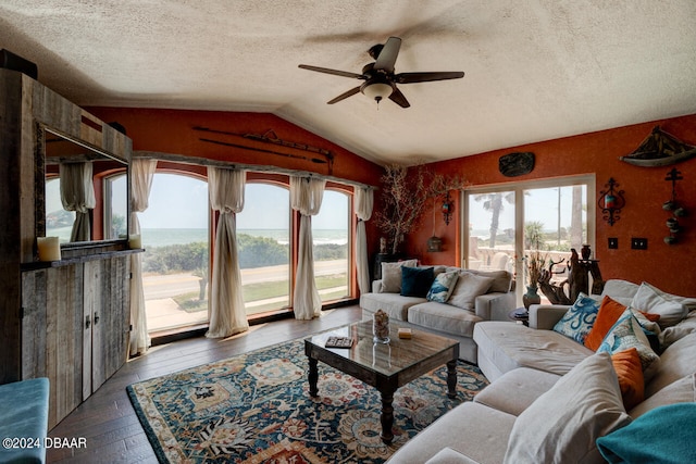 living room featuring ceiling fan, dark hardwood / wood-style floors, lofted ceiling, and a textured ceiling