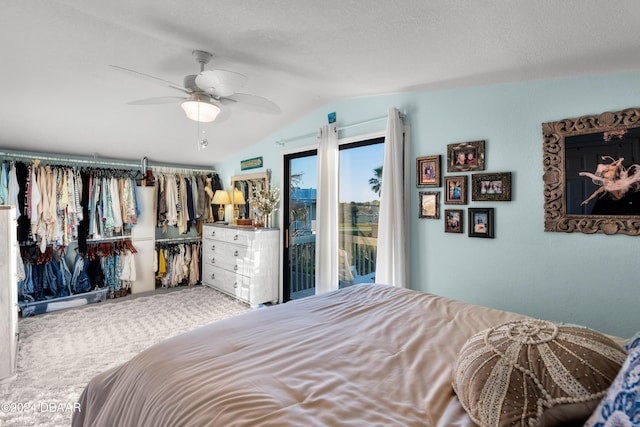 carpeted bedroom with a textured ceiling, access to exterior, ceiling fan, and vaulted ceiling