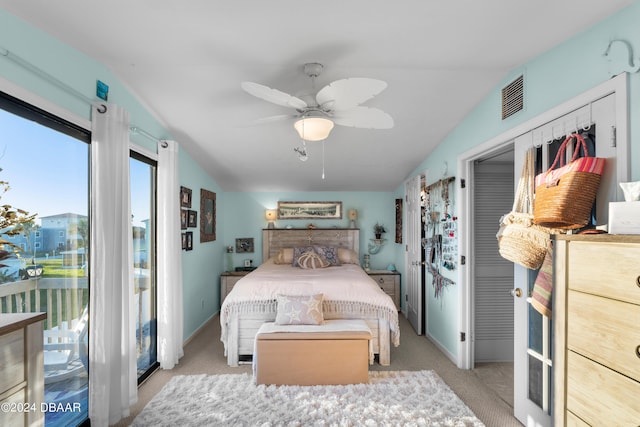 bedroom with light colored carpet, ceiling fan, and lofted ceiling