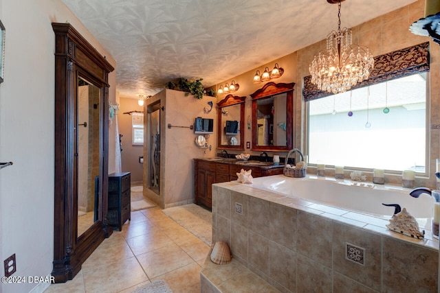 bathroom featuring vanity, tile patterned flooring, plus walk in shower, and a notable chandelier