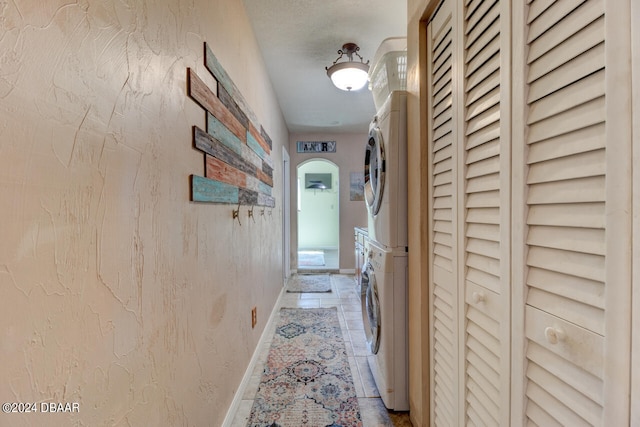 hallway featuring stacked washer / drying machine