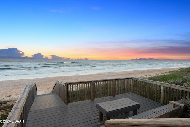 exterior space with a water view and a beach view