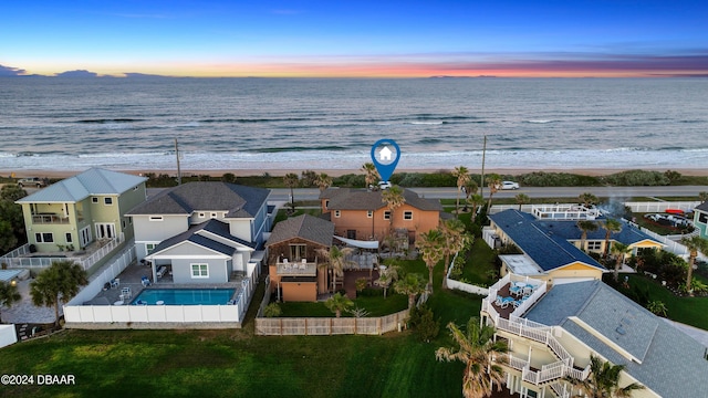 aerial view at dusk with a water view