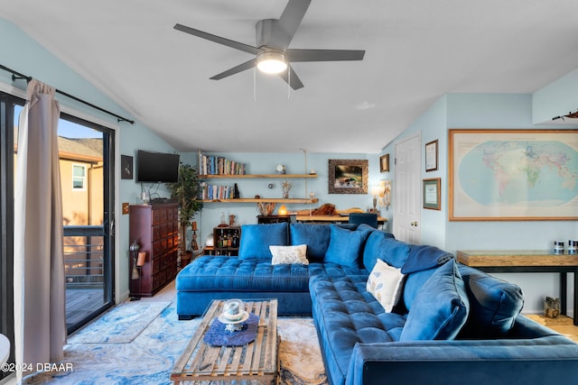 living room featuring ceiling fan and lofted ceiling