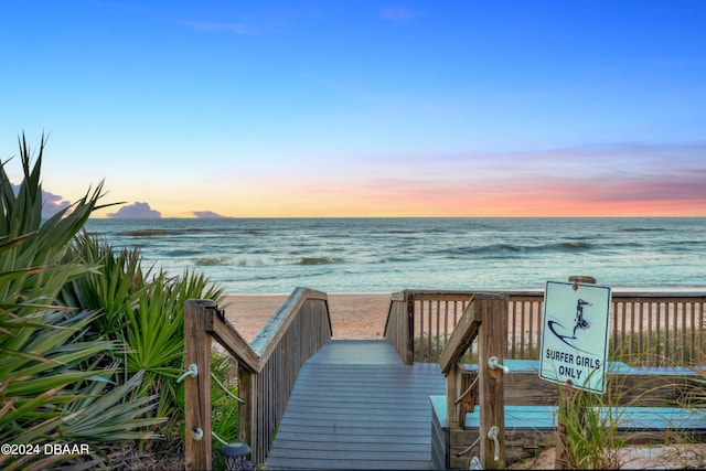 view of property's community with a water view and a view of the beach