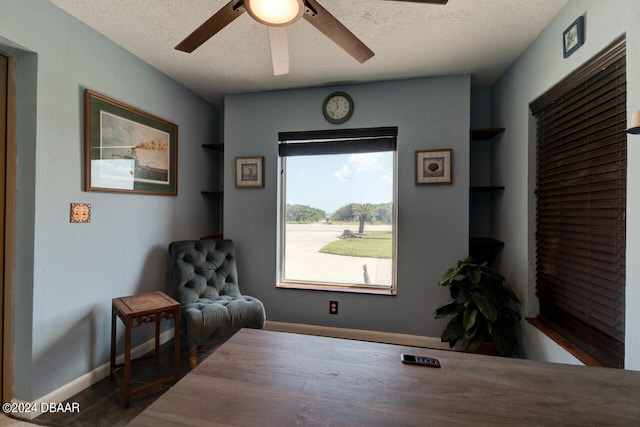 sitting room featuring built in shelves and a textured ceiling