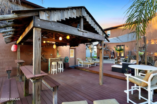 deck at dusk with an outdoor bar