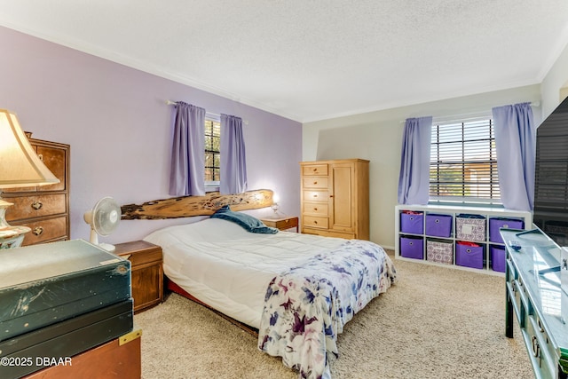 bedroom featuring multiple windows, ornamental molding, light colored carpet, and a textured ceiling