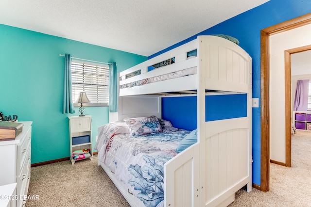 bedroom featuring light colored carpet and a textured ceiling