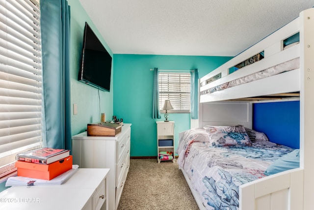 bedroom featuring light carpet and a textured ceiling