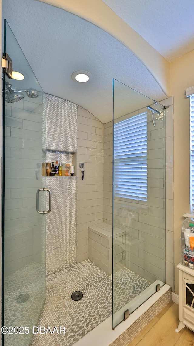 bathroom featuring wood-type flooring and a shower with door