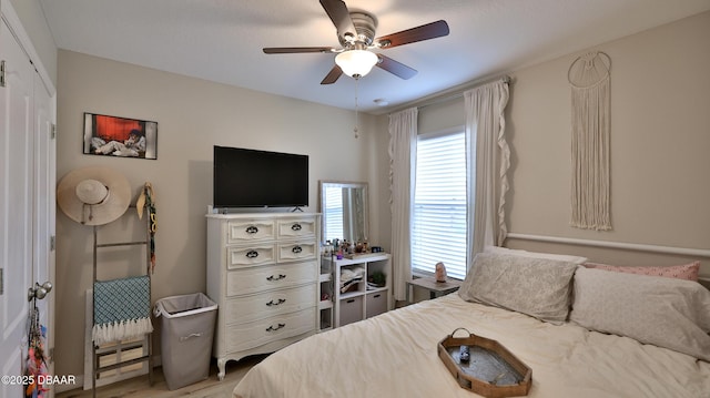 bedroom featuring ceiling fan and a closet