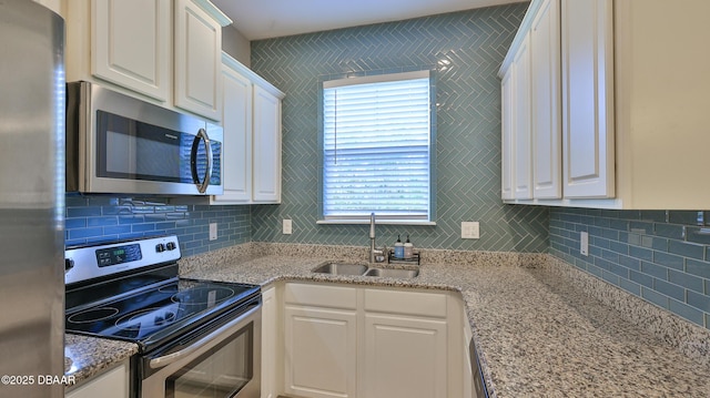 kitchen featuring sink, white cabinets, and stainless steel appliances