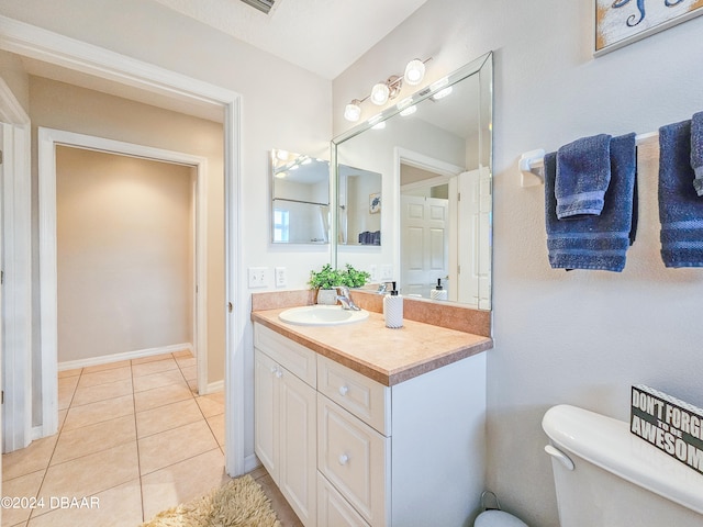 bathroom featuring vanity, tile patterned floors, and toilet