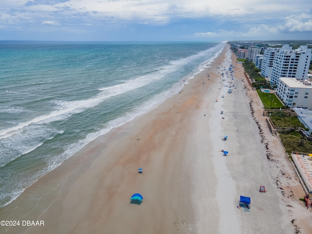 bird's eye view featuring a water view and a beach view