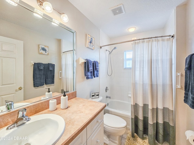 full bathroom with tile patterned flooring, shower / bath combination with curtain, a textured ceiling, vanity, and toilet