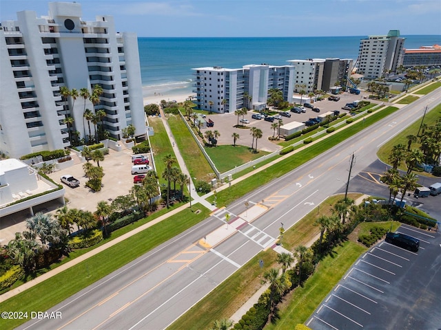 drone / aerial view with a water view and a view of the beach