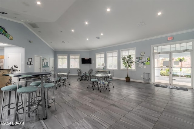 dining area featuring lofted ceiling and ornamental molding