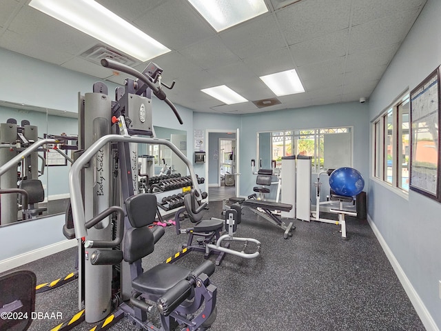 gym with a paneled ceiling