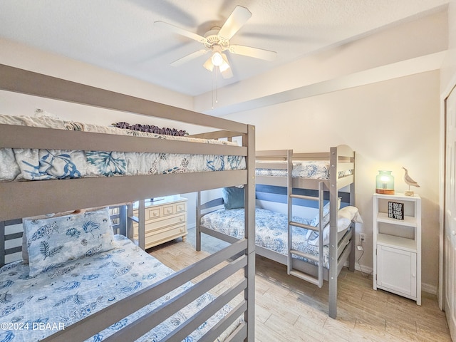 bedroom with light wood-type flooring and ceiling fan