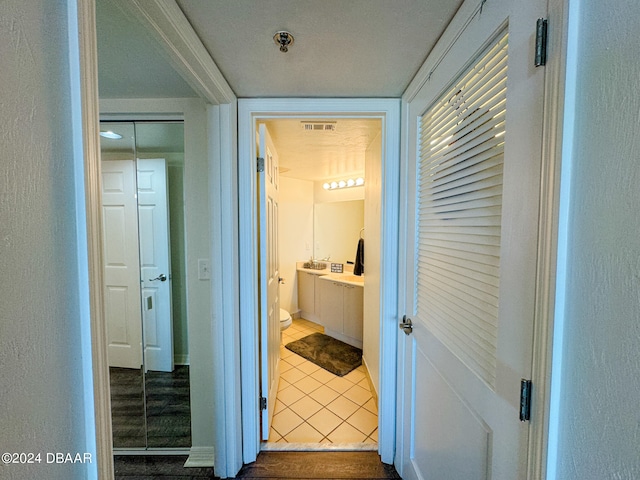 hallway with tile patterned flooring